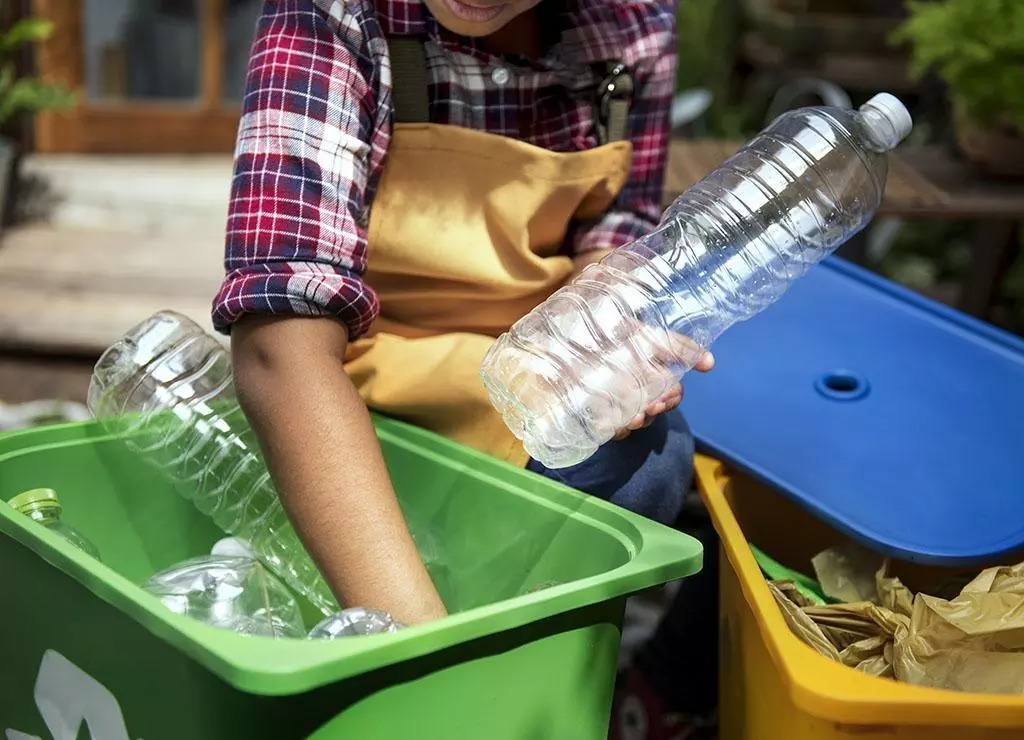 Closeup of hands separating plastic bottles